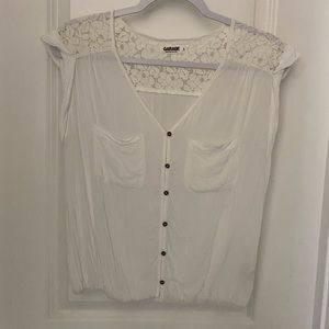White short sleeved top. Gathered at bottom.Flower detailing on shoulders.Size S